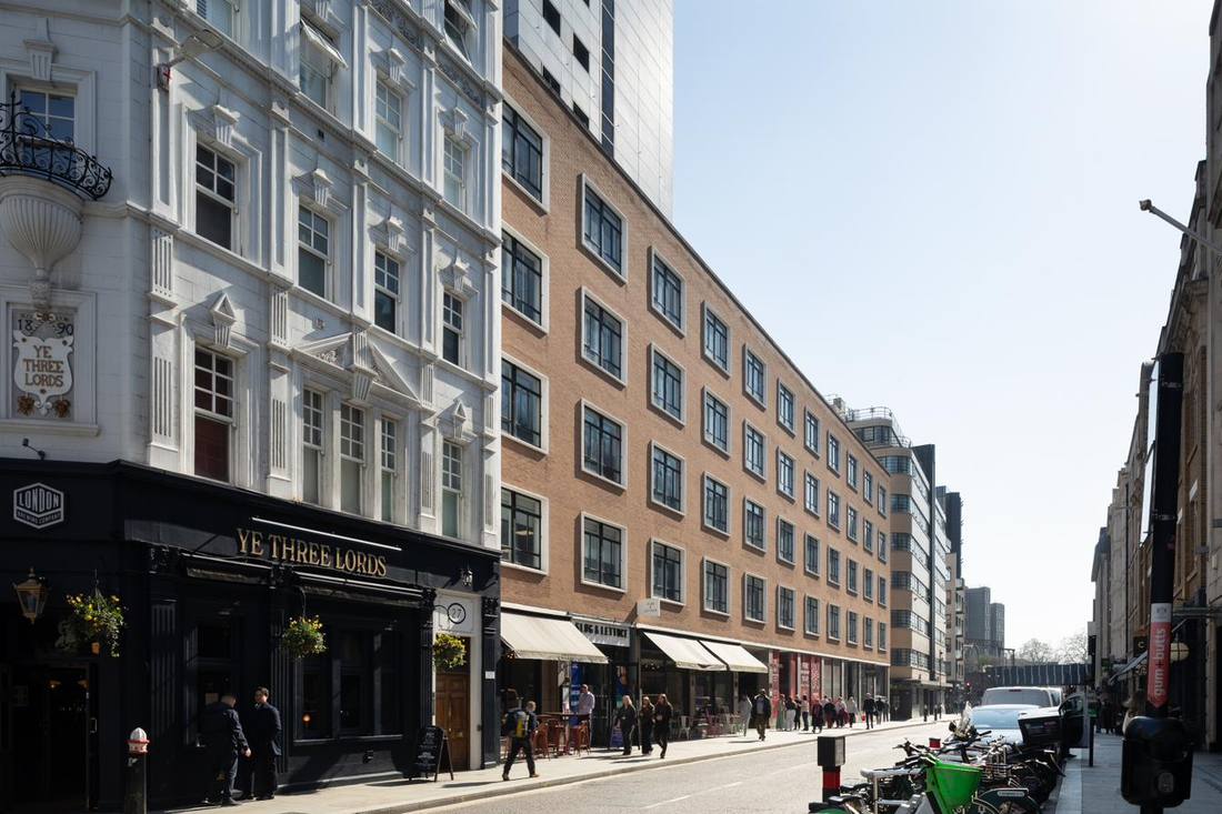 The view down Minories, with Ye Three Lords pub and St Clare House.